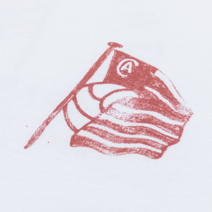 Close up of red chest logo on a white AC Collection tee