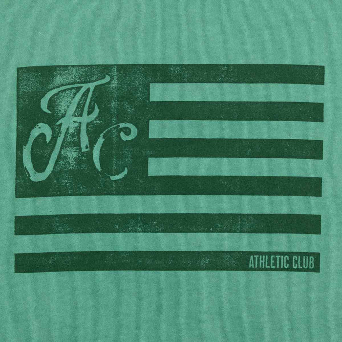 Front view of green Women's AC Collection tee featuring a distressed dark graphic showing AC letters and horizontal stripes