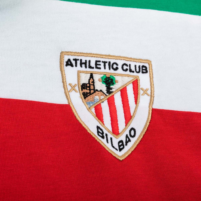 Close up of a retro shirt with Athletic Club Bilbao crest embroidered on white fabric above red panel