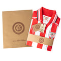 Athletic Club Bilbao junior kit gift set featuring a red and white striped jersey with tags beside a kraft box
