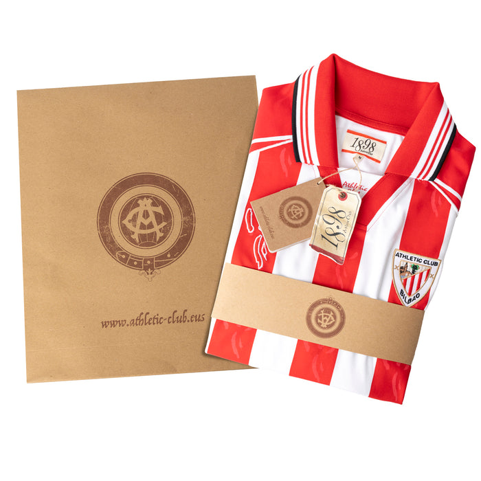 Athletic Club Bilbao junior kit gift set featuring a red and white striped jersey with tags beside a kraft box