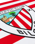 Official Athletic Club Bilbao flag with red and white stripes and crest close up.
