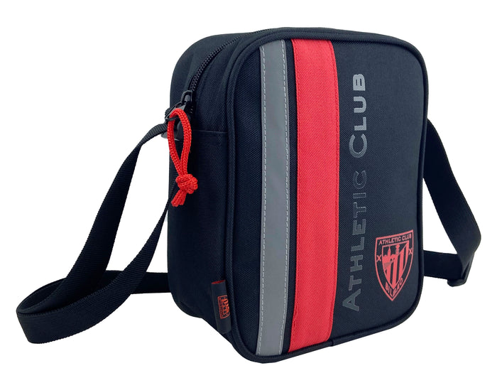 Close up of a navy shoulder bag with a red vertical stripe gray trim and red zipper pull.