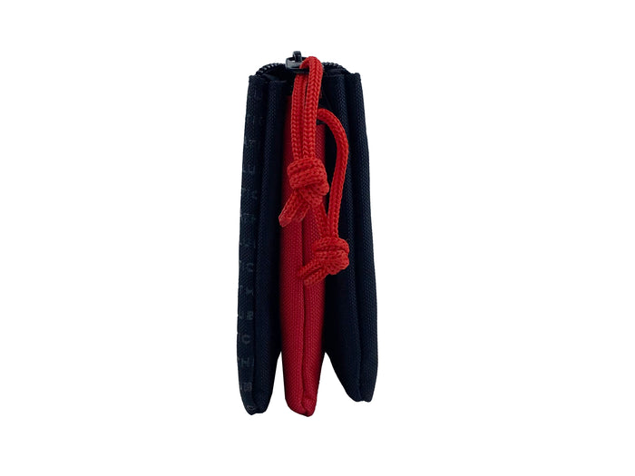 Close up of navy pencil case with bright red drawstrings and zipper pull