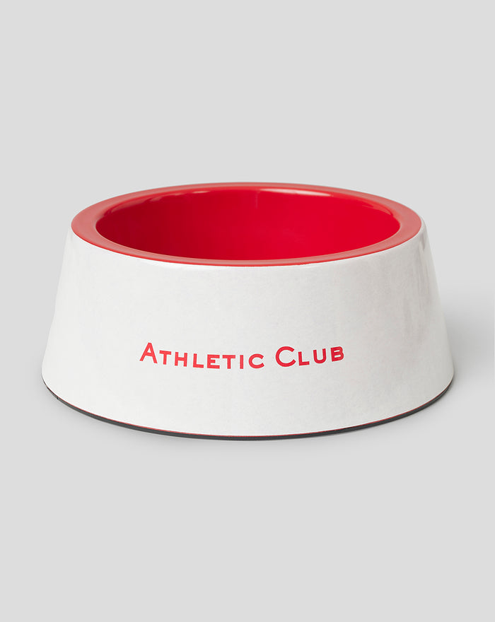White plastic pet bowl with red interior and Athletic Club print