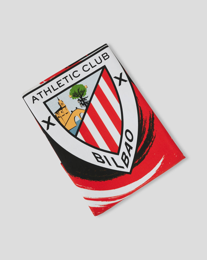 Corner of red and white striped Athletic Club reversible duvet cover with crest