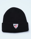 Black beanie with folded cuff and crest patch on the front