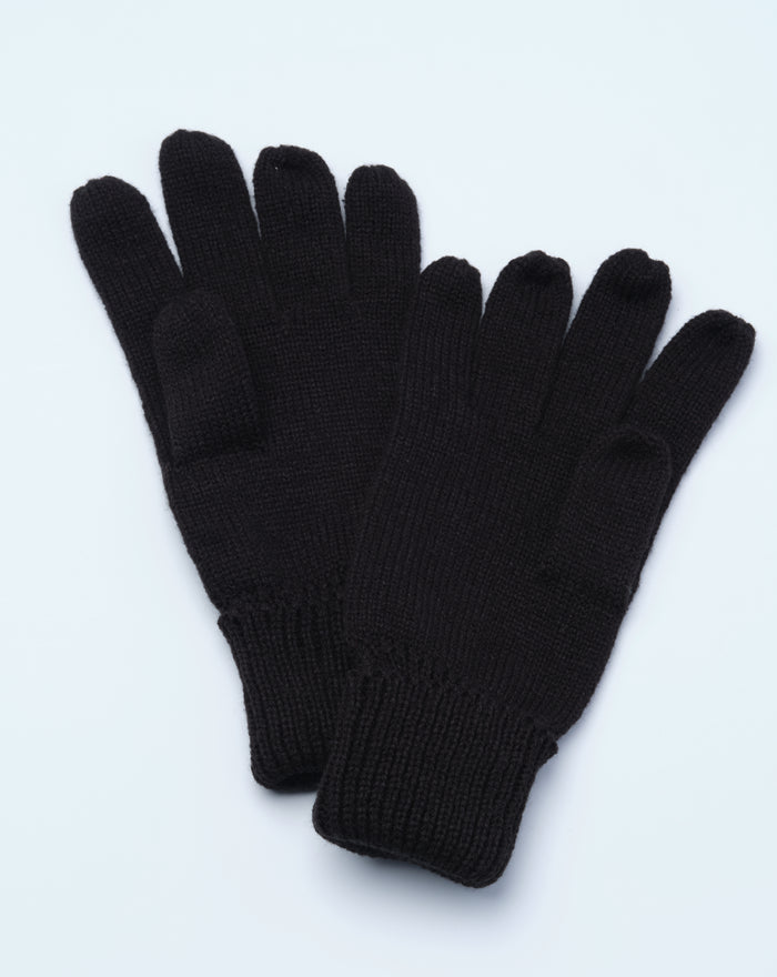 Close up of black knitted gloves showing crest patch on the cuff