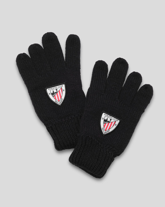 Black junior knit gloves with crest patch on the cuff