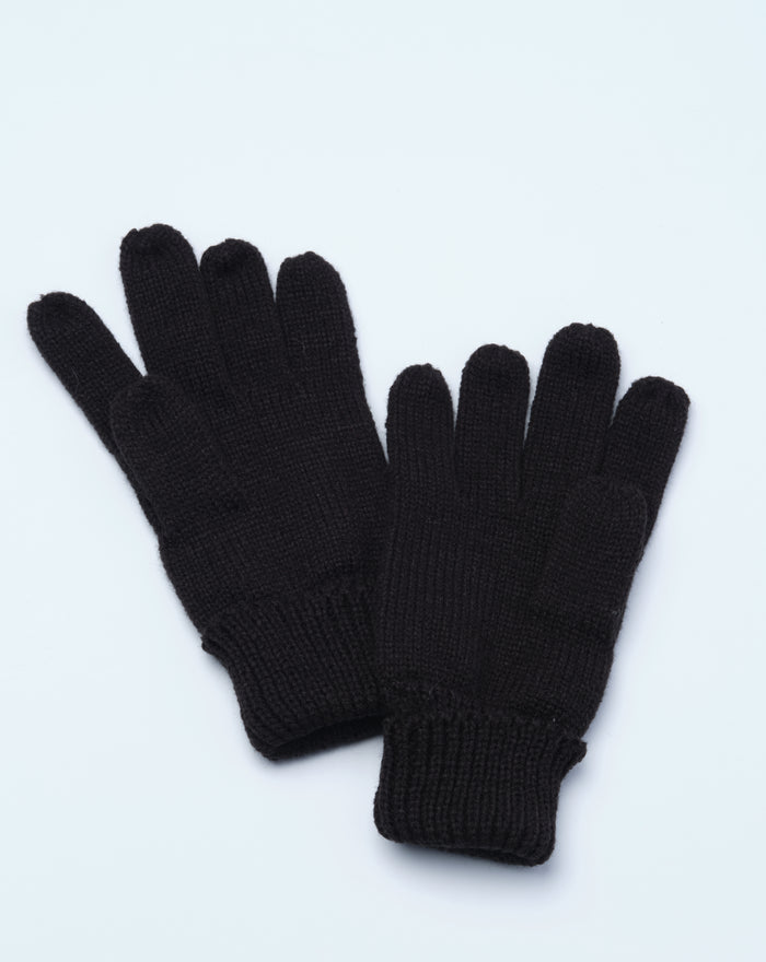 Black knit gloves for juniors laid flat on a light background