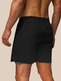 Rear view of black Apex Training Shorts with Castore vertical branding along the left leg and a small hem slit.