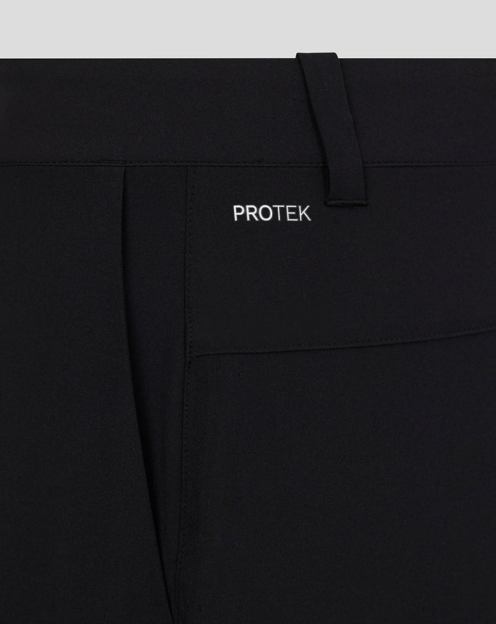 Close up of waistband and belt loop on black golf shorts with PROTEK branding.