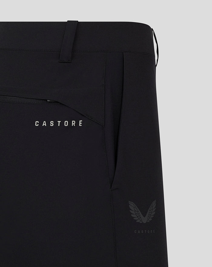 Close up of back pocket area on black golf shorts with CASTORE branding and a wing emblem.