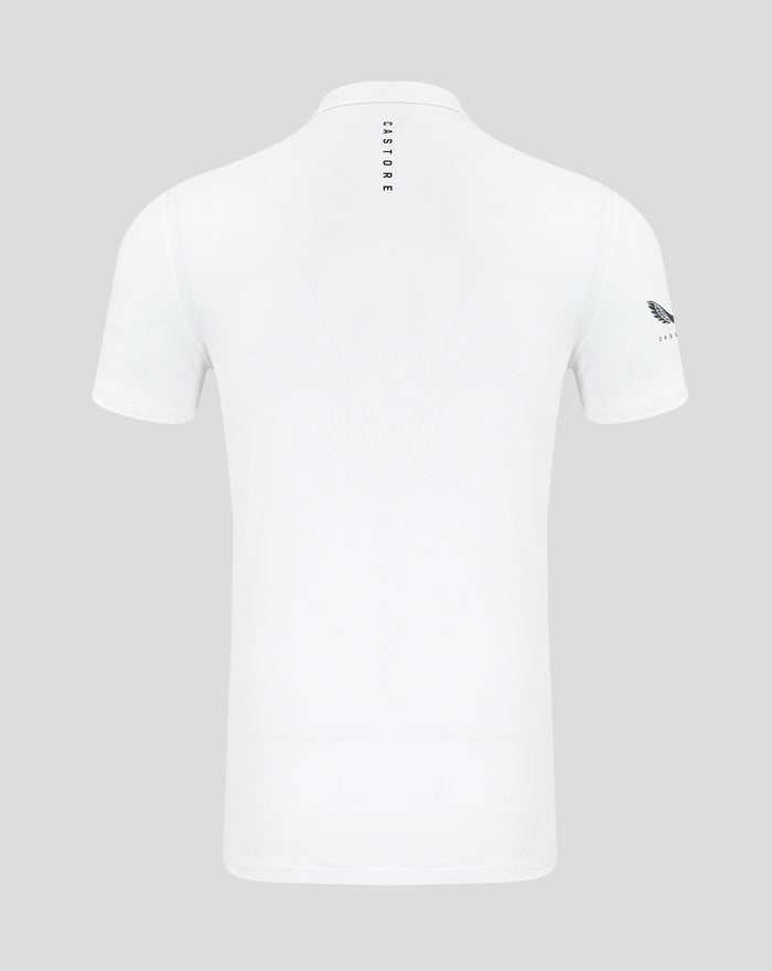Back view of white Castore polo with vertical branding down the back and a crest on the left sleeve
