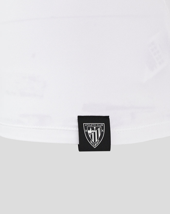 White polo shirt with Athletic Club badge attached at hem