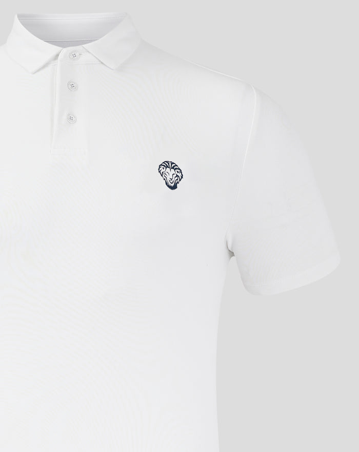 Close-up of white polo collar and placket with chest crest and Castore branding visible