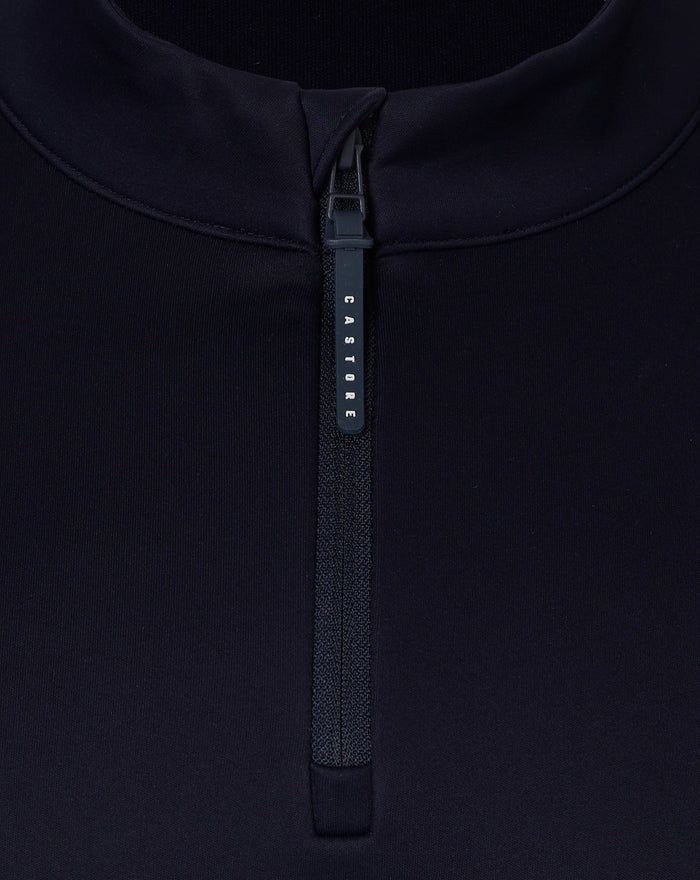 Close-up of a dark navy quarter zip with high collar and Castore branded zipper pull