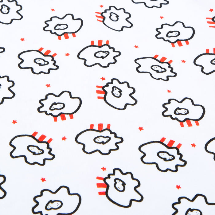 Close-up of all-over cloud pattern on white fabric with black outlines red stripes and small red stars.