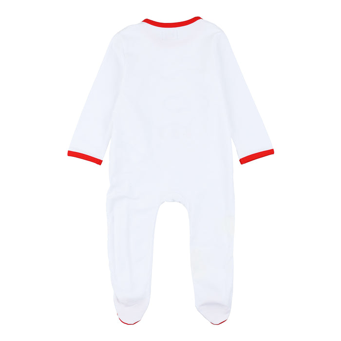 Back view of a white footed baby romper with red trim at neckline and cuffs.