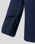 Close-up of navy junior performance midlayer sleeve with curved panel and reinforced stitching.