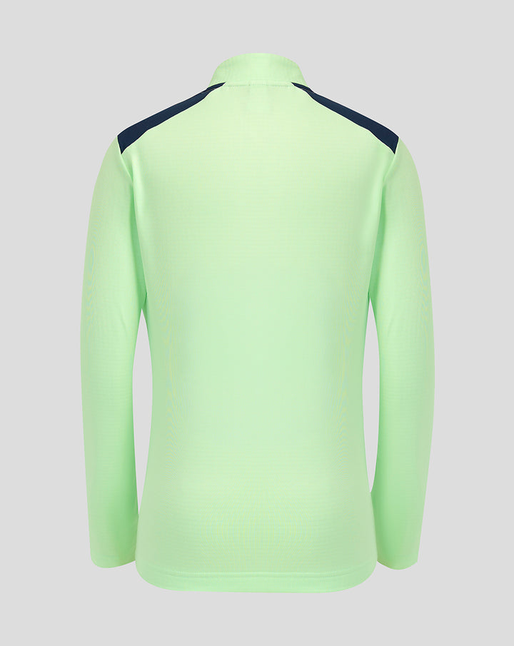 Back view of neon green junior performance midlayer top with dark navy shoulder panels.
