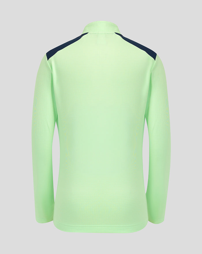Back view of neon green junior performance midlayer top with dark navy shoulder panels.