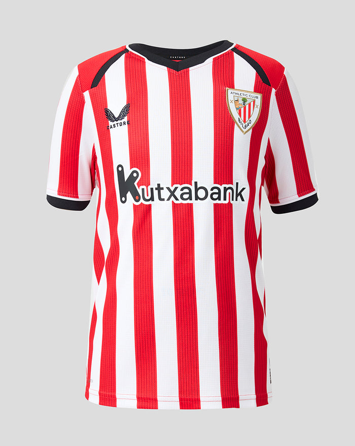 Front view of junior Home shirt with red and white vertical stripes, club crest on chest and Kutxabank sponsor