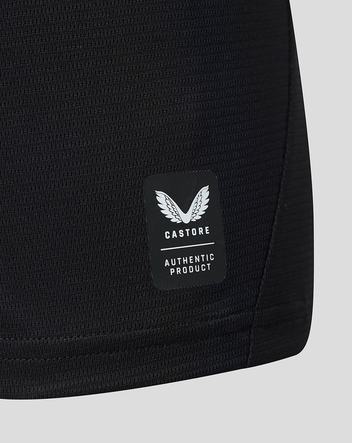 Close up of black jersey fabric showing Castore authentic product patch with white wings