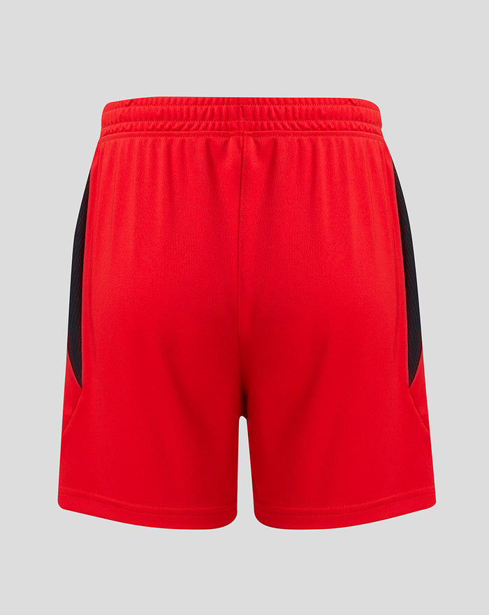 Rear view of red junior shorts with black mesh side panels and CASTORE branding at the hem