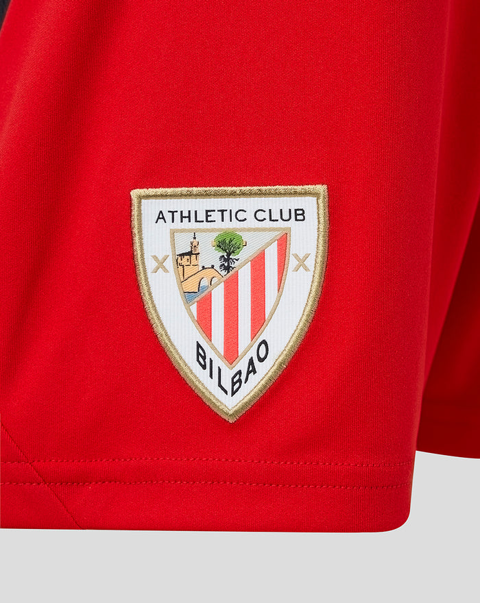 Close up of red junior away shorts fabric with Athletic Club Bilbao crest patch