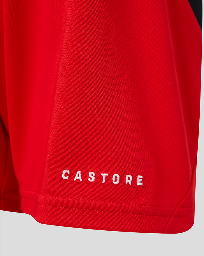 Close-up of the red shorts hem with white CASTORE embroidery on the leg