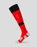 Red junior away change sock shown on leg with a black band and Athletic Club branding