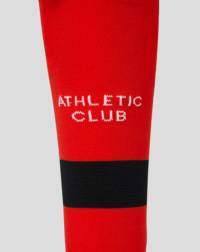 Close up of red sock with white Athletic Club text and black stripe near the cuff