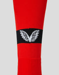 Junior red away change sock with black band and white leaf logo
