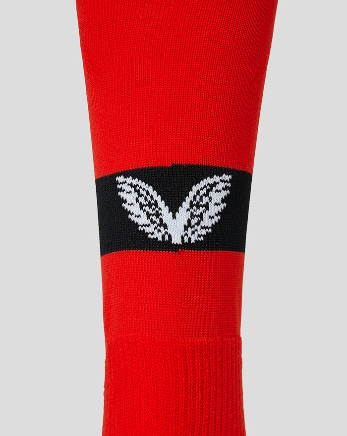 Junior red away change sock with black band and white leaf logo