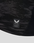Castore authentic product badge on the black camo goalkeeper jersey fabric near the hem