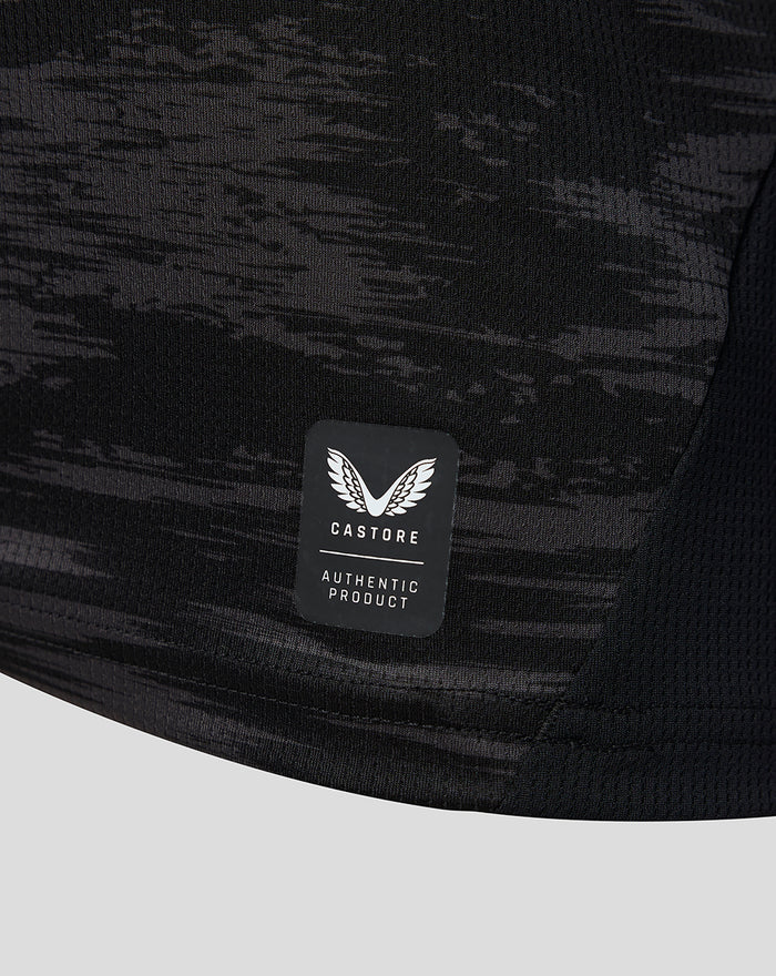 Castore authentic product badge on the black camo goalkeeper jersey fabric near the hem
