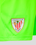 Close up of neon green goalkeeper shorts with Athletic Club Bilbao crest patch near the hem
