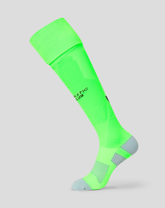 Neon green junior away goalkeeper sock with grey toe and heel and black Athletic Club logo.