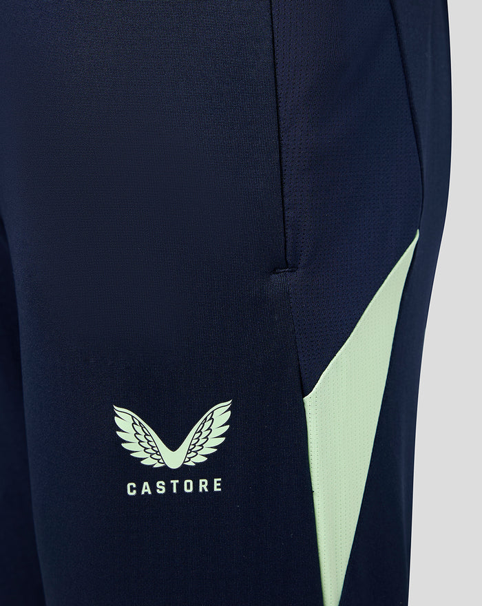 Junior navy performance pants with pockets, mint side panel and Castore logo
