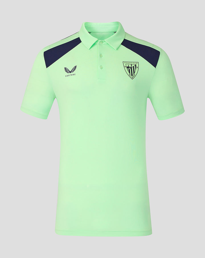 Front view of neon green performance polo shirt with navy shoulder panels and club crest