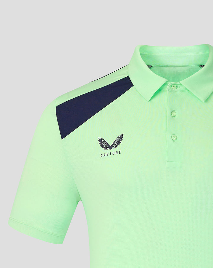 Close up of left chest showing Castore logo and club crest on neon green polo