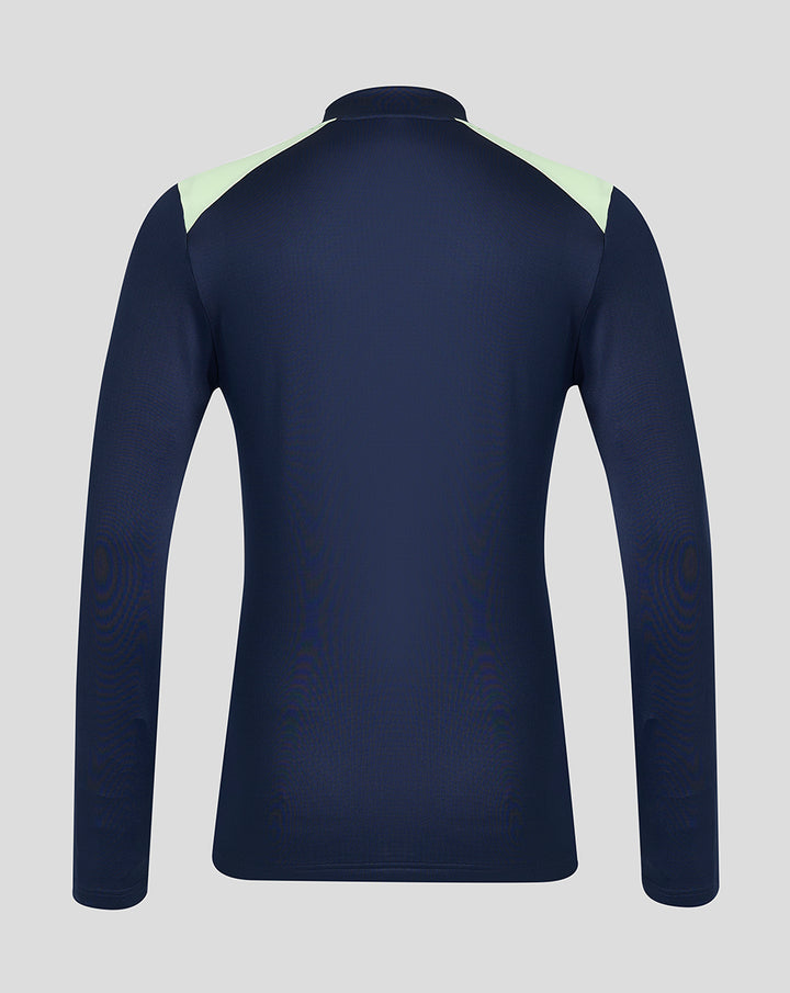 Back view of navy performance midlayer top with pale lime shoulder panels.