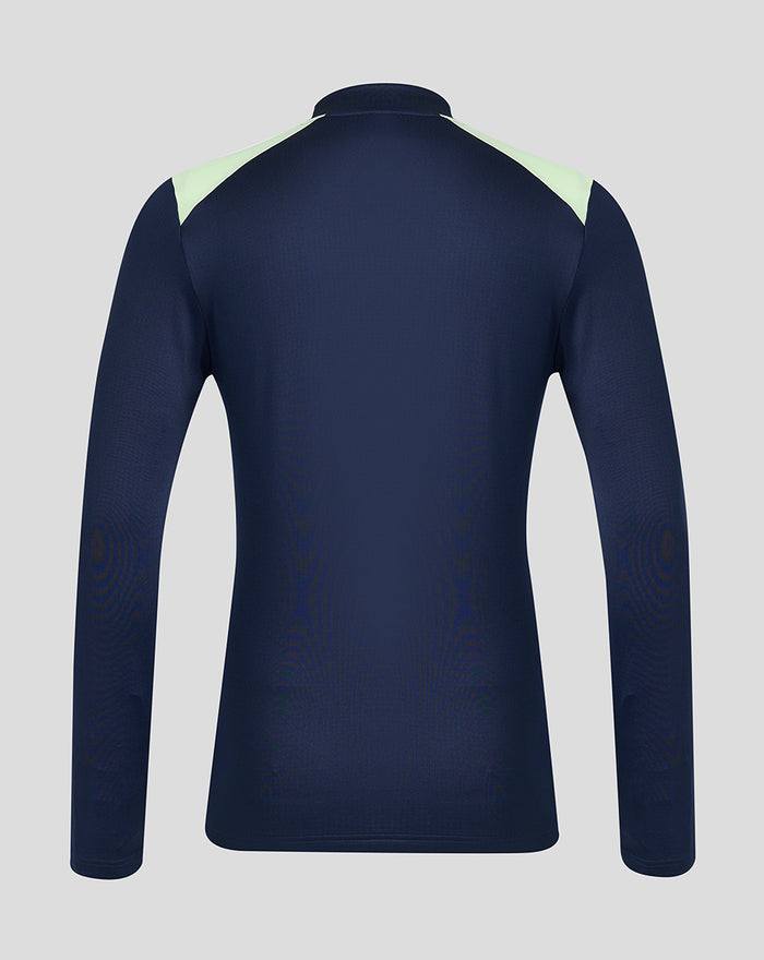 Back view of navy performance midlayer top with pale lime shoulder panels.