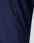 Detail of navy jacket side with vertical zipper pocket.