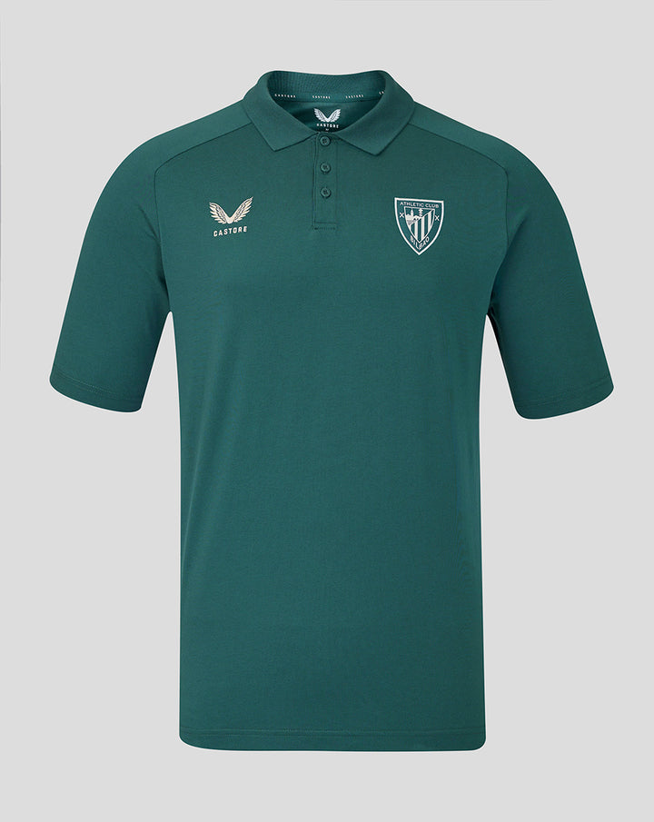 Front view of OFF PITCH POLO JUNIOR in teal with Castore logo on the left chest and a shield team crest on the right chest.