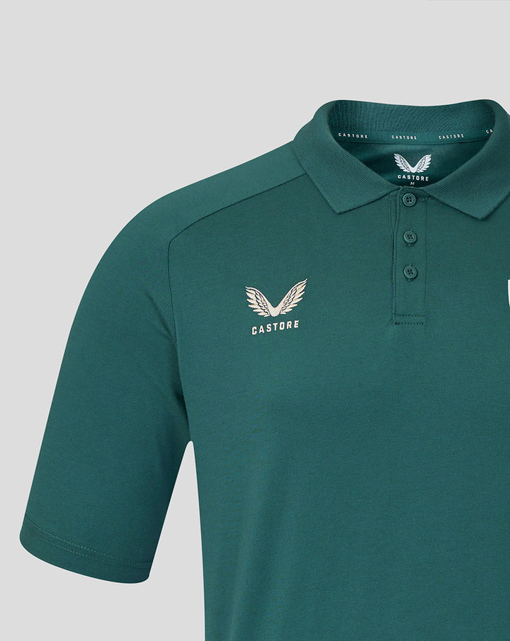 Close up of teal OFF PITCH POLO JUNIOR showing Castore logo on the left chest and the team crest near the collar.