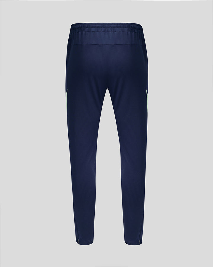 Back view of navy performance pants with elastic waistband and neon side panels.