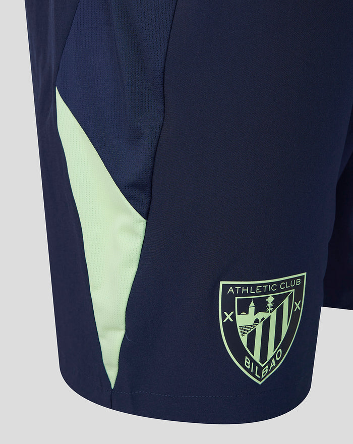 Side view of navy performance shorts with neon mint panel and Athletic Club Bilbao crest