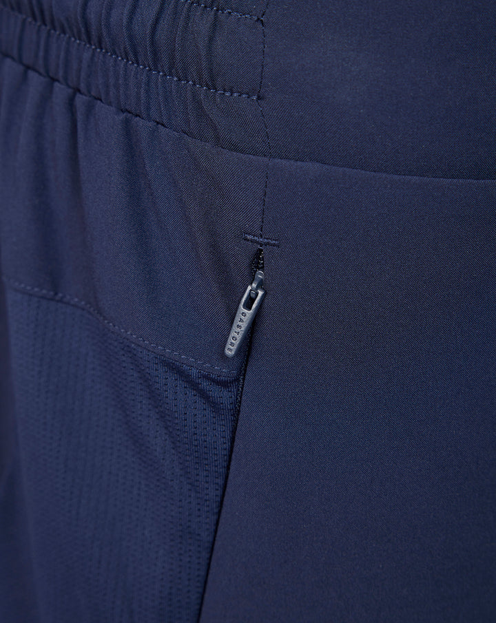 Close-up of navy shorts showing a zippered side pocket.